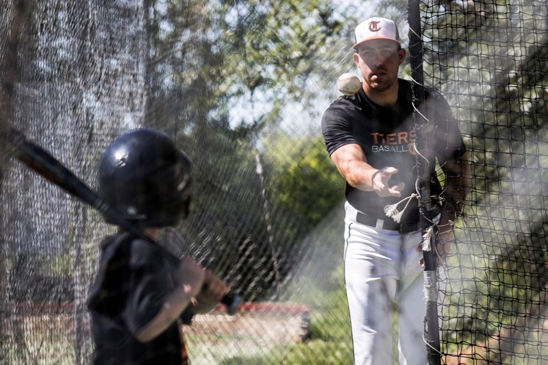 SKILL SESSION â€“ St. Albert Tigers pitcher Alejandro Garcia tossed a few practice pitches for young players looking to improve their hitting during the annual Tigers