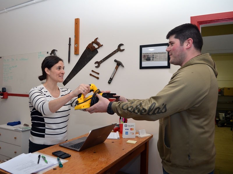 Edmonton Tool Library board member Shannon Leblanc lends out a circular saw.