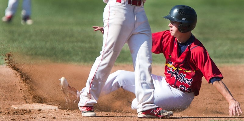 BASE STEALER â€“ Damian Obrigewitch of the St. Albert Cardinals slides into second base during action in the Norwest Midget AAA Baseball League. The Cardinals are 12-2 in