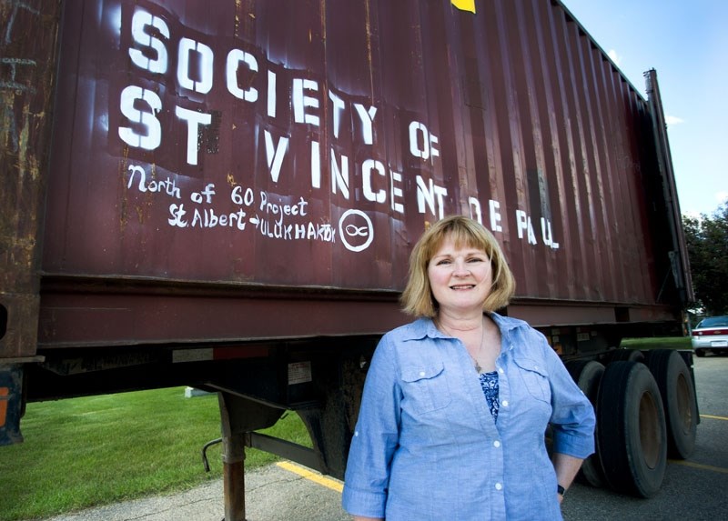 Linda Tutt poses with the seacan.The local conference of the St. Vincent de Paul Society has been collecting necessities and amenities to send via seacan to Ulukhaktok