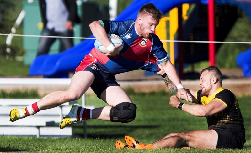 TRIPPED UP â€“ Trent Bennett of St. Albert is pulled down to the pitch in Friday&#8217;s third division match against the Leduc Crude in the Edmonton Rugby Union. The thirds