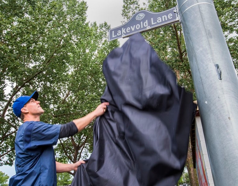 LAKEVOLDS HONOURED â€“ Cody Lakevold unveils the Lakevold Lane sign for the Legion Memorial Park driveway during the St. Albert Minor Baseball Association ceremony honouring