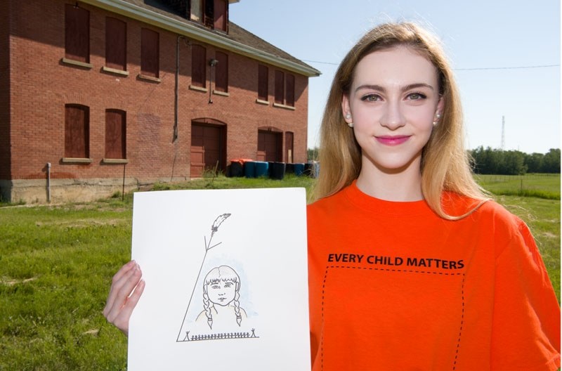 SHIRTS WITH MESSAGE â€“ St. Albert Catholic High School graduate Arlyssa McArthur displays the winning design she made for the Safe and Caring School society&#8217;s Orange