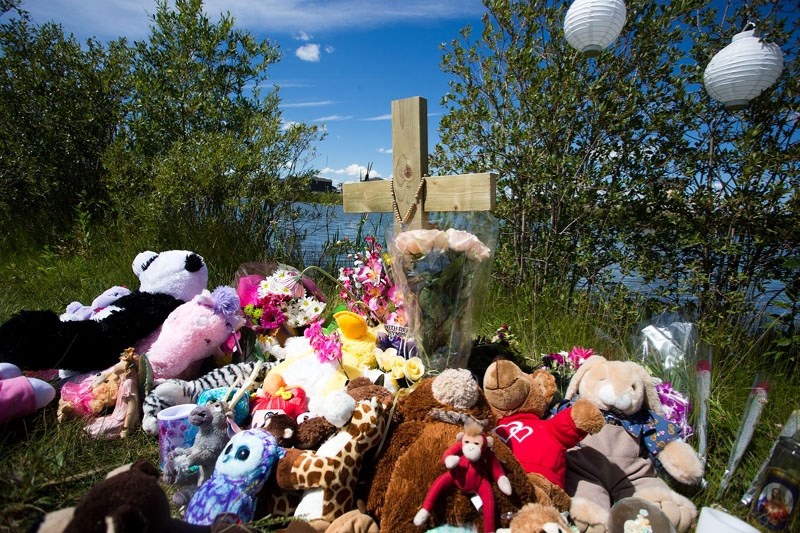 A memorial was set up last July in Morinville near the site where a toddler drowned. Her parents have been charged by the RCMP.