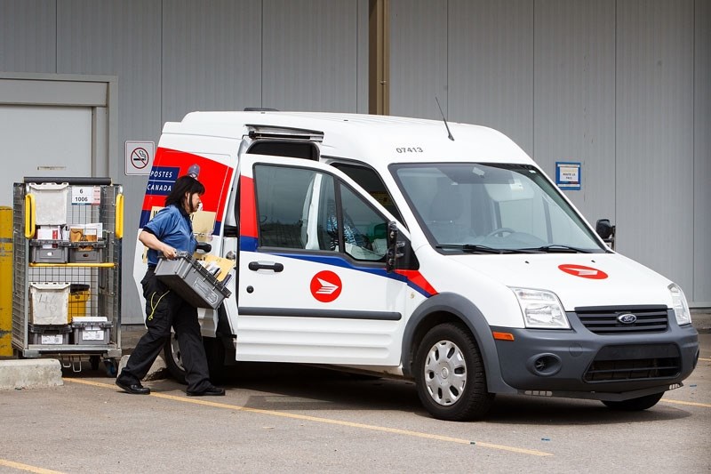 A postal worker loads a Canada Post van at the post office in Campbell Park on Tuesday. Canada Post issued a 72-hour lockout notice early Tuesday morning.