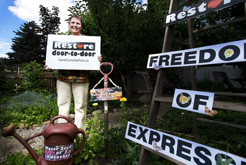 Grandin resident Tara Seeger responded to a bylaw notice to remove her &#8216;Save Canada Post&#8217; sign by installing several other homemade signs supporting freedom of