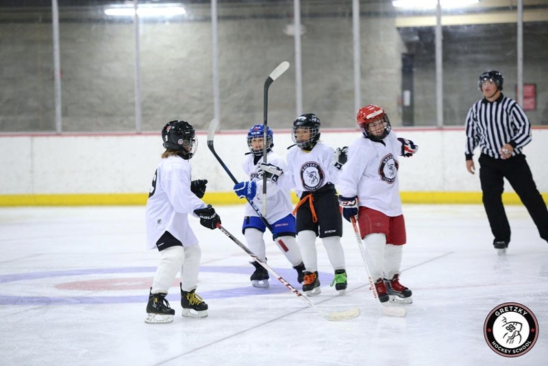 A group of Gretzky Hockey School students preparing to face off in a game on the final day of camp.