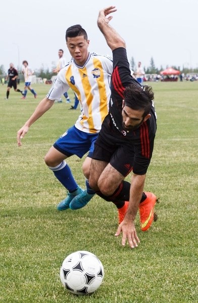St. Albert&#8217;s Henry Jeong looks on as AC Milan&#8217;s Kais Hama loses the ball during division 1B men&#8217;s soccer action between the St. Albert Impact #2 men and AC