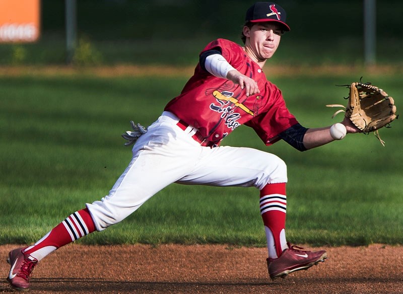 St. Albert Midget AAA Cardinals player Zach Froment leaps for a ball during their game against the Parkland Twins at Legion Memorial Park on Wednesday.