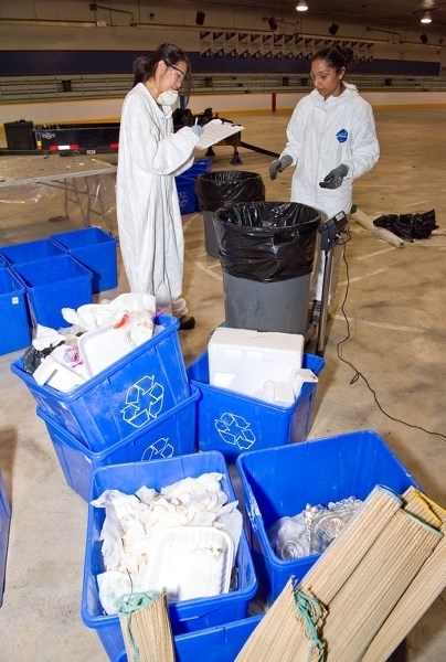 JUNK SCIENCE â€” Isabella Luu (left) and Leanne Moreira of the Recycling Council of Alberta weigh some sorted waste last July 20 at the Ray McDonald Arena as part of