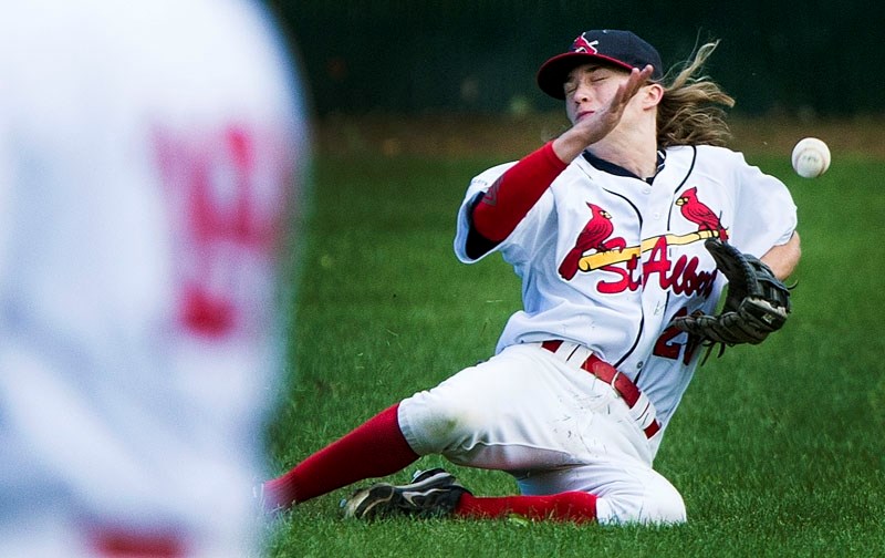 PLAYING THE BALL â€“ Anthony Owen attempts to make a catch in the outfield for the St. Albert Cardinals in the Norwest Midget AAA Baseball League. The Cardinals are in