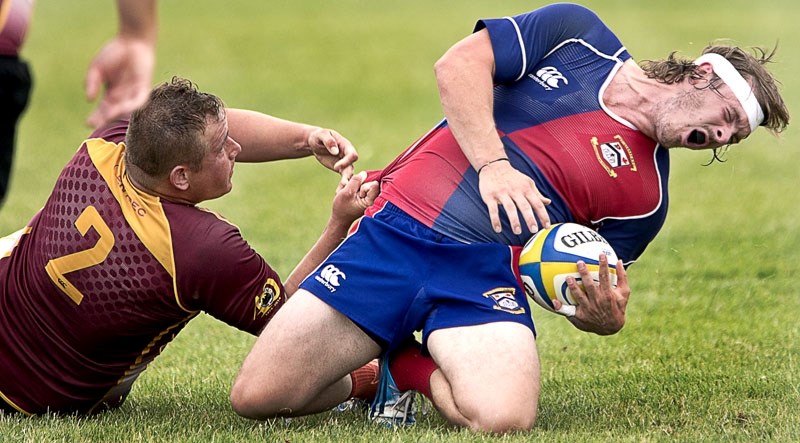 TUG OF WAR â€“ Mitch Millett of the St. Albert Rugby Football Club reacts to having his jersey pulled by Aubrey Cillers of the Nor&#8217;Westers in Saturday&#8217;s premier