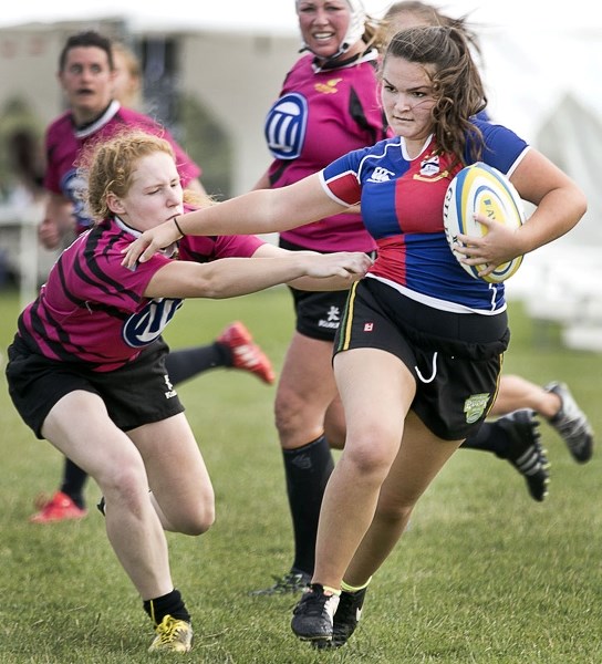 RUNAWAY â€“ Kolby Krueger of the St. Albert Rugby Football Club breaks past a defender in Saturday&#8217;s 73-22 thumping of the visiting Grande Prairie Sirens. SARFC (7-2)