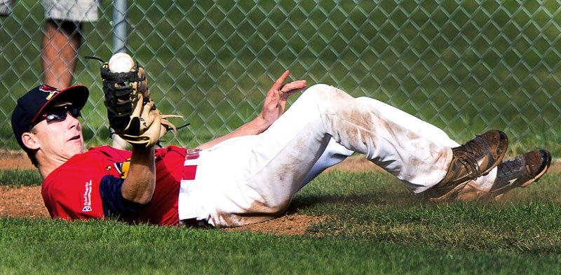 CATCH OF THE DAY â€“ First baseman Adam Olsen of St. Albert Cardinals Red hangs on to the ball in Friday&#8217;s tournament opener against the Swift Current Indians at the