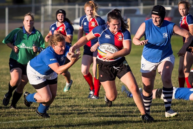 HURRY HARD â€“ Kolby Krueger of the St. Albert Rugby Football Club charges through the Pirates for a try to end the first half in Wednesday&#8217;s 38-36 victory. The home