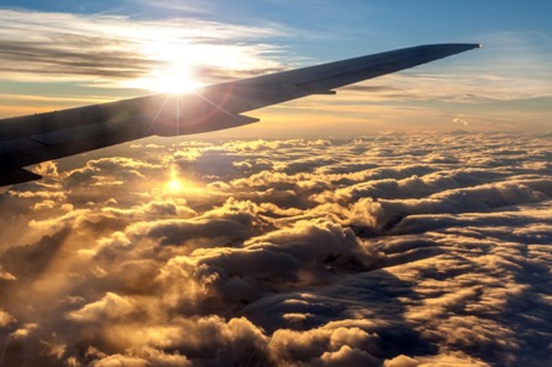 Sun over airplane wing