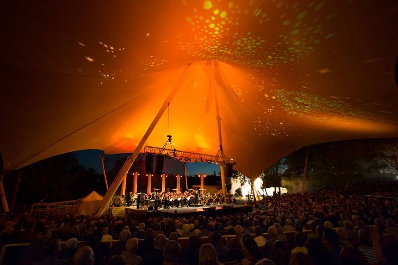 The Edmonton Symphony Orchestra performing Symphony Under the Sky at Hawrelak Park is a true spectacle of music and swirling orange special effects.