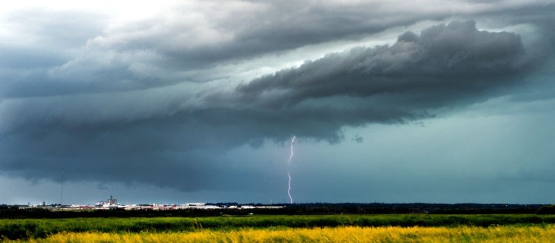 A shelf cloud begins to form as lightning strikes southwest of St. Albert on July 30. This was just one of many lightning storms in a summer that dropped 20 per cent more