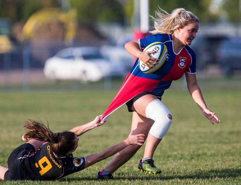 HANGING ON â€“ A desperate Jacqueline LeBlanc of Crude/West tries to slow down Kiera Arndt of the St. Albert Rugby Football Club in Wednesday&#8217;s division one match in
