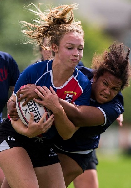 TACKLED â€“ MacKenzie Doughty of St. Albert is caught by a Clan player in division one women&#8217;s action in the Edmonton Rugby Union. The St. Albert Rugby Football Club