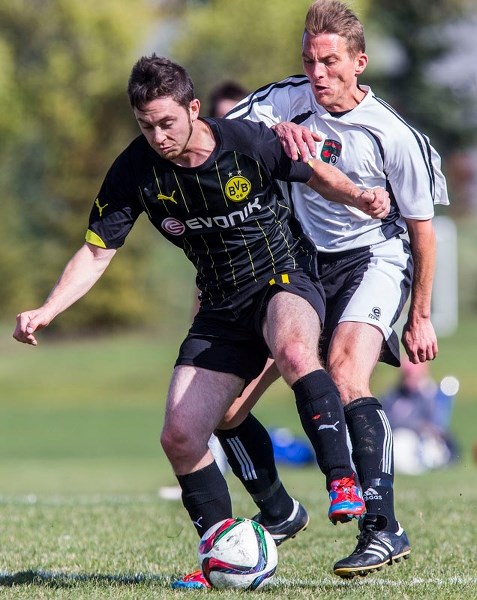 CLOSE ENCOUNTER â€“ Andrew Di Timoteo of Prestige Worldwide is pressured from behind by Craig Cameron of the Forest Park Rangers in the St. Albert Men&#8217;s Soccer League