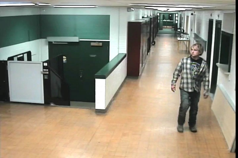 A lone male suspect in his late teens was caught on camera breaking into the Morinville Public School by throwing a piece of lumber through the door.