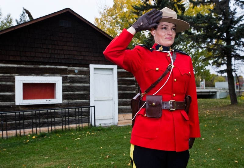 TIMELESS POLICING â€“ St. Albert RCMP Cst. Jennifer Fraser stands at attention by the BLESS Summer Nature Centre cabin in her dress uniform. Today&#8217;s RCMP carries on a