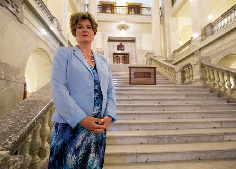 Alison Azer poses in a file photo at the Alberta Legislature earlier this year.