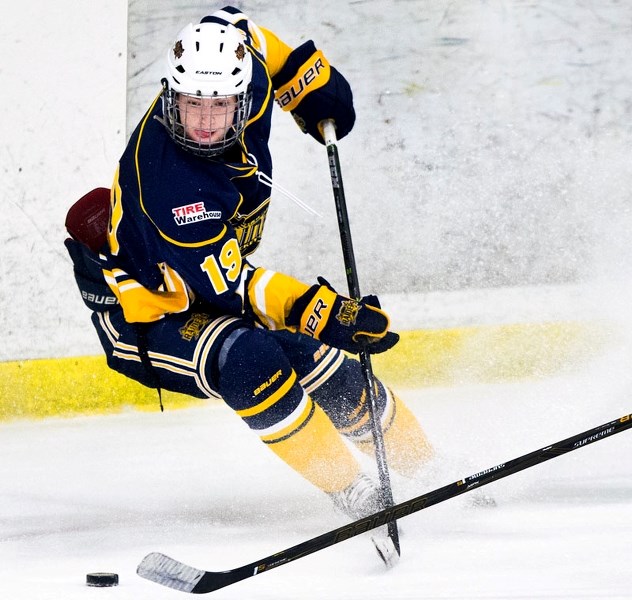 PUCK RETRIEVAL â€“ Peter Corrigan makes a play for the puck with the St. Albert Tire Warehouse Raiders in the Alberta Midget AAA Hockey League. The Raiders host the SEAC