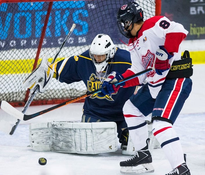 GOAL-LINE STAND â€“ Chris Curr of the St. Albert Tire Warehouse Raiders stops a shot in front of Josh Stypka of the Canadian Athletic Club in Sunday&#8217;s midget AAA game