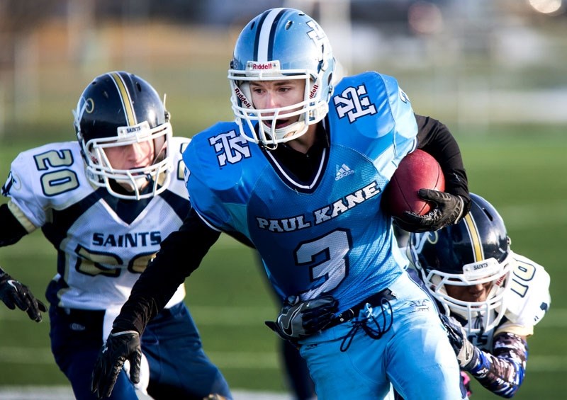 FRONT-RUNNER â€“ Brenden Wagensveld of the Paul Kane Blues is pursued by a pair of St. Joseph Saints in Tuesday&#8217;s 48-20 victory at Riel Recreation Park. Wagensveld