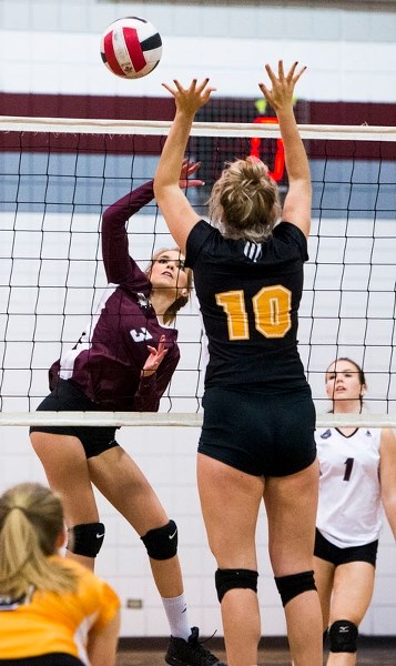 POWER PLAY â€“ Willow Heisler of the Bellerose Bulldogs hits the ball over the net with Erika Kruk in the background in Tuesday&#8217;s 25-14