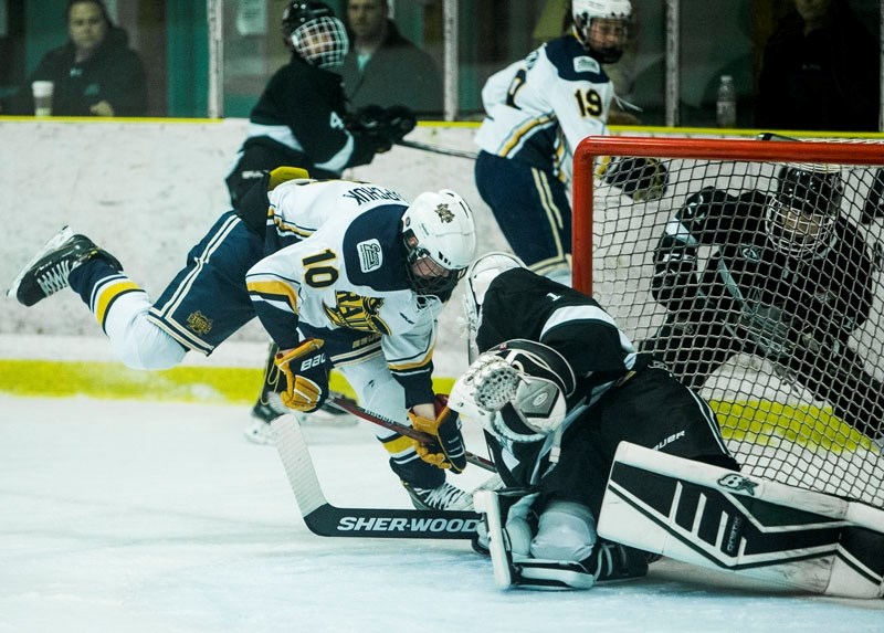 PERSISTENCE â€“ Zack Ostapchuk of the St. Albert Gregg Distributors Sabres digs for the puck as Brady Roblin guards the net for the Sherwood Park Flyers in Thursday&#8217;s
