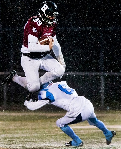 HURDLER â€“ Bellerose Bulldogs quarterback Quade Kozak jumps over D&#8217;Andre Plaizier of the Paul Kane Blues in Carr conference division one action last month. The