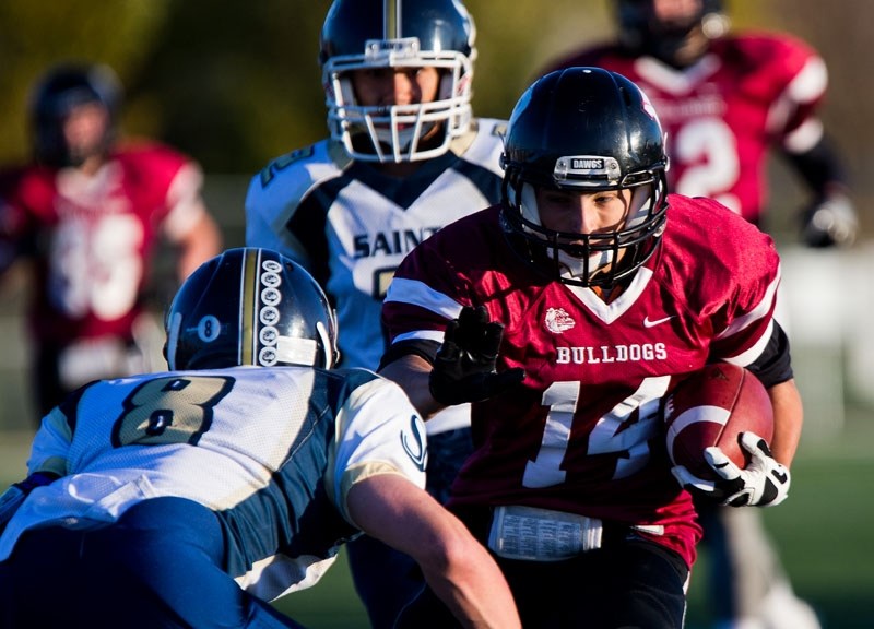 DAWG ON THE LOOSE â€“ Sheldon MacKay of the Bellerose Bulldogs carries the ball in metro Edmonton high school junior football action. The winners of the last four division