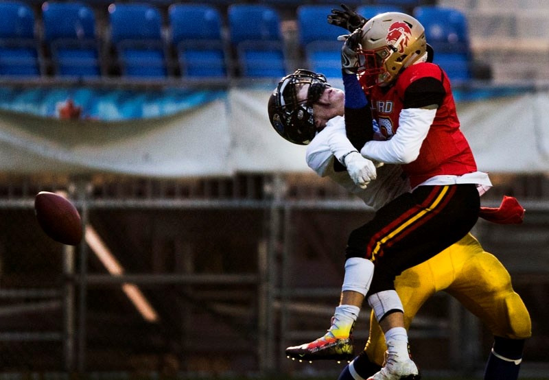 INTERTWINED â€“ Connor Lotoski of the St. Albert High Skyhawks gets tangled up while going for the ball in Friday&#8217;s semifinal against the Strathcona Lords. The Skyhawks 