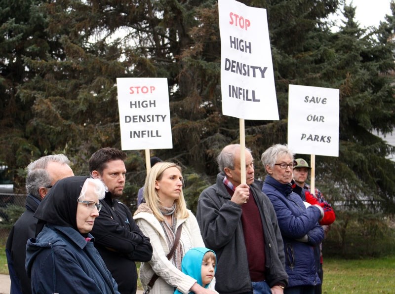 Protesters and curious onlookers gathered at the public site walk event hosted by a consultant on behalf of the develper who is proposing a rezoning and land swap with the
