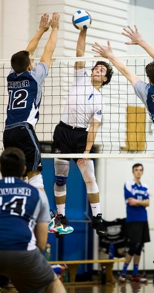 LIFTOFF â€“ Landon Bishop jumps high to spike the ball for the Paul Kane Blues in the metro Edmonton division two senior men&#8217;s playoffs. The Blues beat the St. Peter