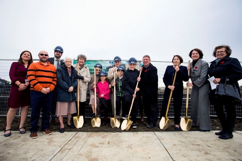 Dignitaries participate in a sod-turning event to commemorate the groundbreaking of Sister Alphonse Academy in St. Albert on Wednesday.