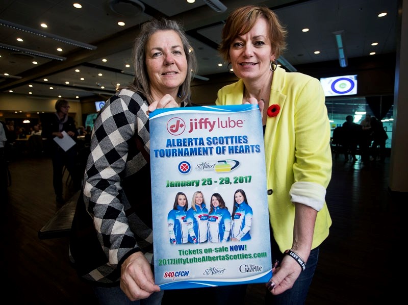 READY TO ROCK â€“ Karen Stephen and Nicole Bellamy of the organizing committee for the Jiffy Lube Alberta Scotties Tournament of Hearts display the promotional poster for the 