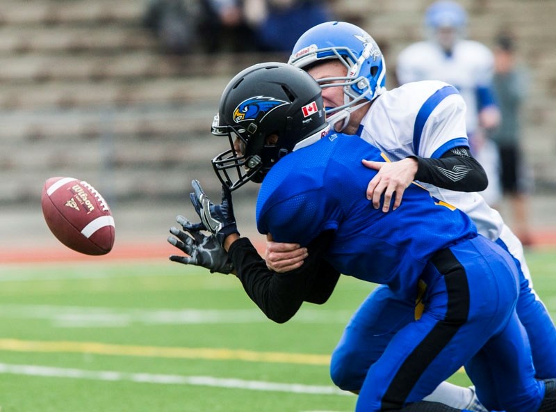 INTERFERENCE â€“ DeAmonte Overman of the St. Albert High Skyhawks is interfered with while looking to make a catch against the Peace Wapiti Academy Titans in the Tier III