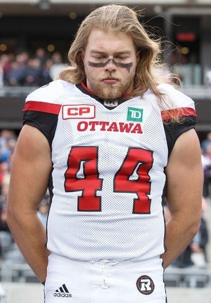 DEEP IN THOUGHT â€“ Tanner Doll of the Ottawa RedBlacks is absorbed in the task at hand during the national anthem at the June 13 pre-season game against Winnipeg Blue
