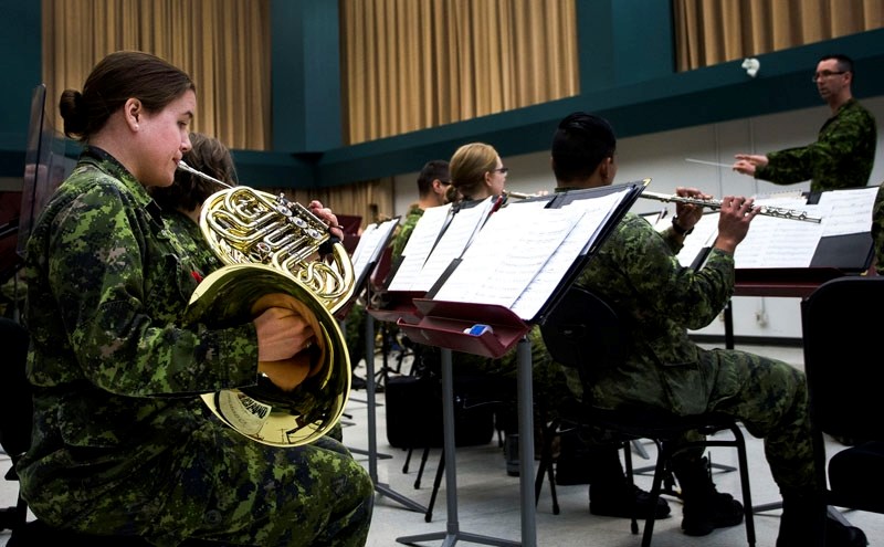 Corporal Angie Dolomount plays the french horn in the Royal Canadian Artillery Band during a media event at the Edmonton Garrison earlier this month.
