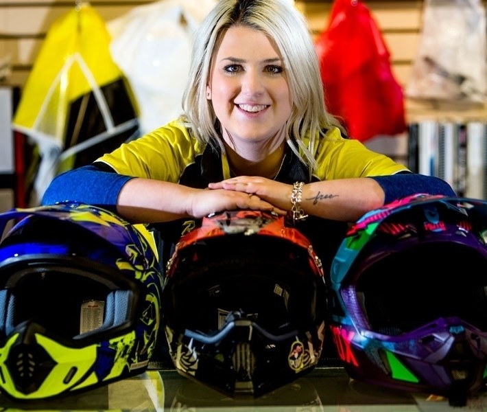 WEAR A HELMET â€“ Kathryn Walker of Riverside Honda &amp; Ski-Doo in St. Albert shows off a selection of full-face ATV helmets. The province tabled legislation Monday that
