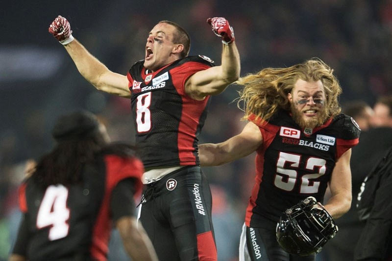 JUBILATION â€“ Tanner Doll (52) of St. Albert and Jake Harty (8) celebrate the Grey Cup victory by the Ottawa Redblacks over the Calgary Stampeders on Sunday at BMO Field in
