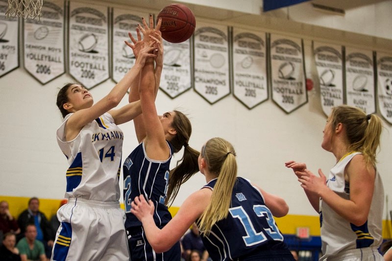 CONFRONTATION â€“ Sarah Dedrick of the St. Albert Skyhawks and Anika Steele of the Paul Kane Blues challenge for a rebound in the Feb. 8 metro Edmonton division one tilt at