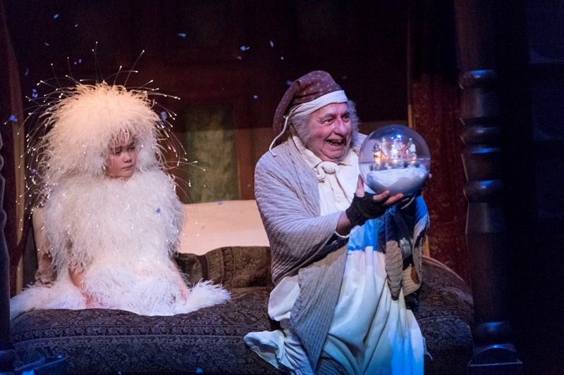 Ebenezer Scrooge (Tom Wood) journeys to his childhood with the Ghost of Christmas Past (Lilja Radstaak) in A Christmas Carol now on at the Citadel Theatre.
