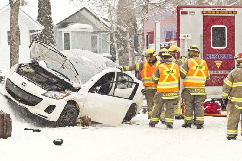 LESS OF THIS â€“ Firefighters examine one of two vehicles involved in a collision along Larose Drive in this December 2013 photo. A recent study by Allstate Insurance