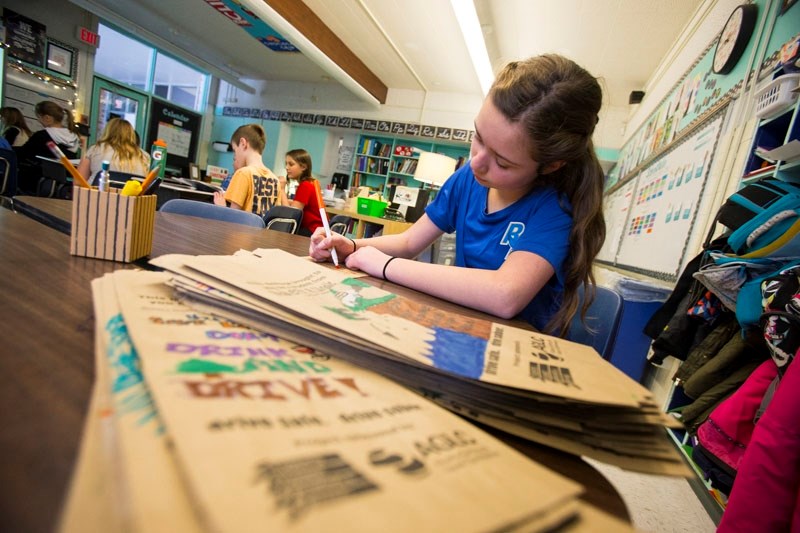 Tegan Knutson was one of several Robert Rundle Elementary School Grade 6 students to design and decorate liquor bags with anti-drunk driving messages on Tuesday