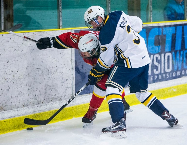 CLOSE ENCOUNTER â€“ Robert Kincaid of the St. Albert Gregg Distributors Sabres battles for the puck along the boards against Matthew Mazzocchi of the Calgary Flames in